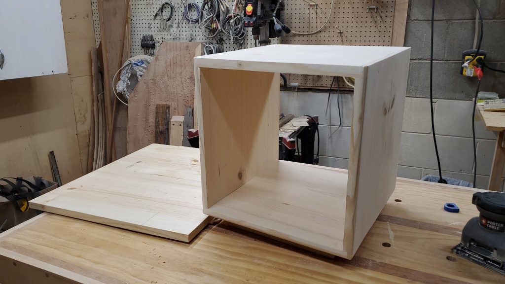 A photo of the final cube and table top after sanding and routing of the edges before assmebly